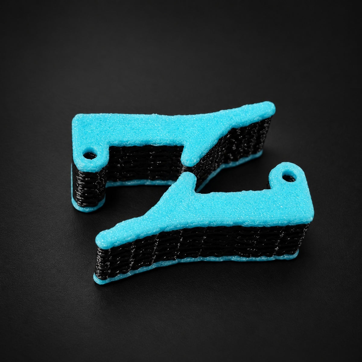 Side view of Apache 1800 kit latches in black with turquoise accents.